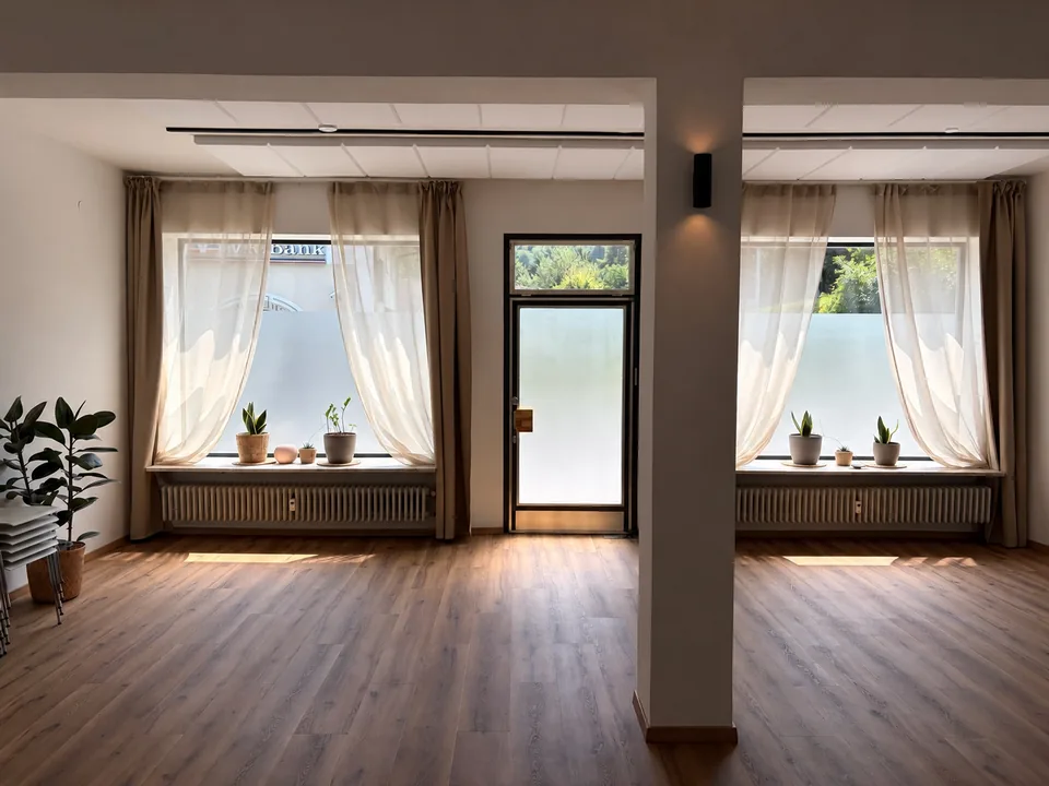 Das helle Freiraum-Studio mit großen Fenstern und Eingang direkt in den Hauptraum